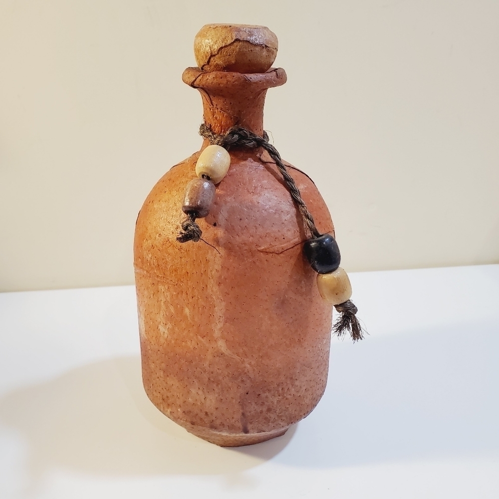Vintage handmade wrapped ceramic bottle